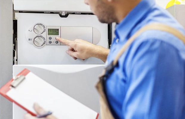 engineer evaluating the central heating system for a power flushing